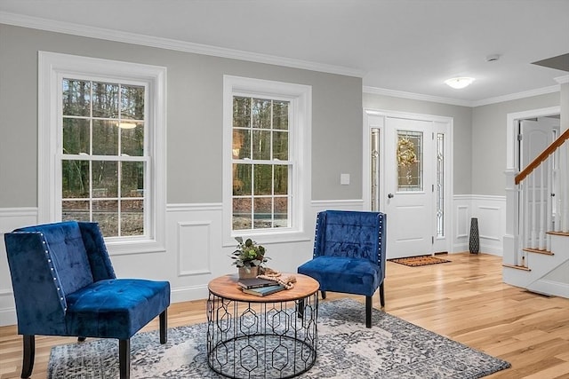 62 Bolton Rd Applewood, Unit Applewood, Westminster, MA 01473 - living area with stairs, light wood-style floors, ornamental molding, healthy amount of natural light, and a wainscoted wall