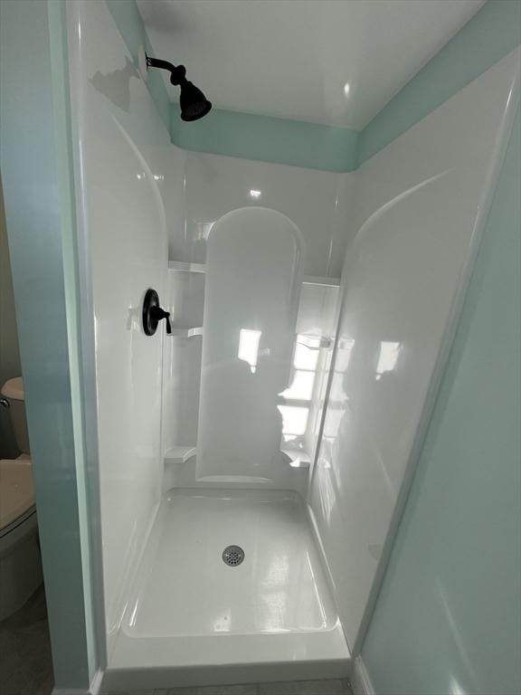 bathroom with toilet and walk in shower