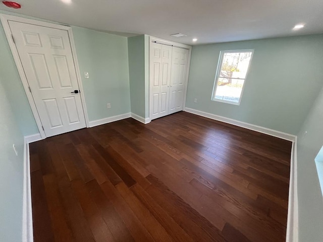 unfurnished bedroom featuring dark hardwood / wood-style flooring