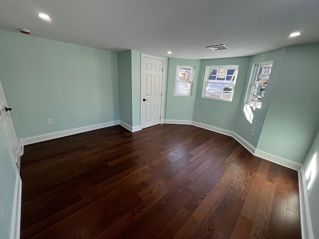 spare room featuring dark wood-type flooring