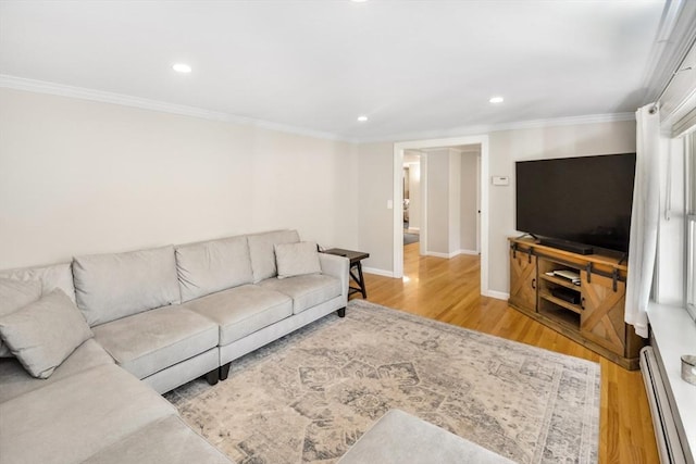 living area with recessed lighting, baseboards, wood finished floors, a baseboard heating unit, and ornamental molding