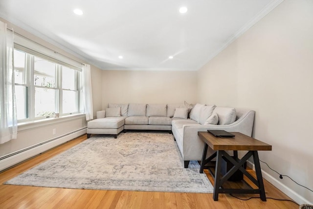 living area featuring ornamental molding, a baseboard heating unit, recessed lighting, and wood finished floors