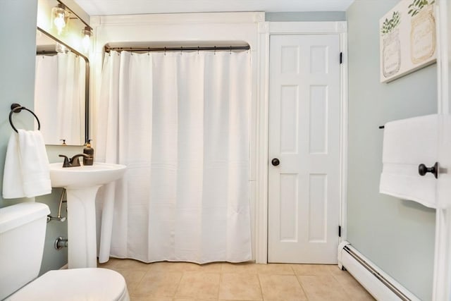 full bathroom with toilet, baseboard heating, tile patterned floors, a shower with curtain, and a sink