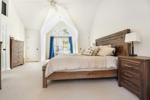 bedroom featuring a ceiling fan, light carpet, and vaulted ceiling