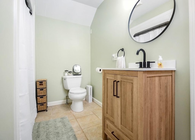 bathroom featuring vanity, tile patterned flooring, baseboards, and toilet