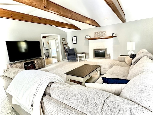 carpeted living area with a glass covered fireplace and baseboards