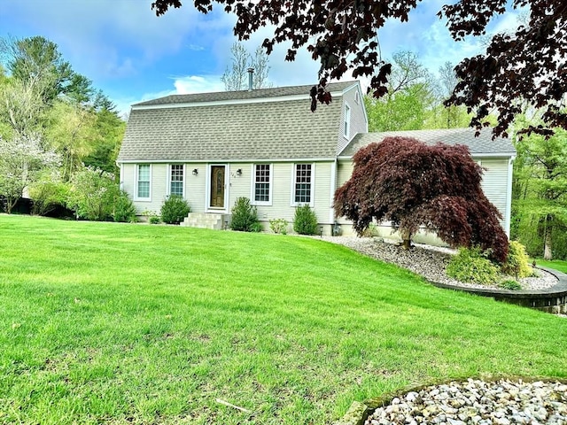 colonial inspired home with a front lawn and a shingled roof