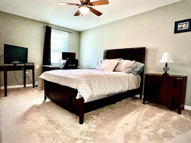 carpeted bedroom with baseboards and ceiling fan