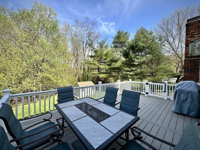 wooden deck featuring outdoor dining area