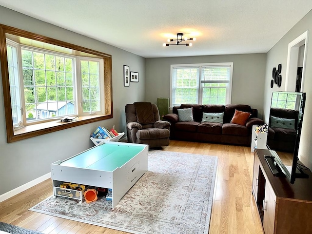 living room featuring light wood-style flooring and baseboards