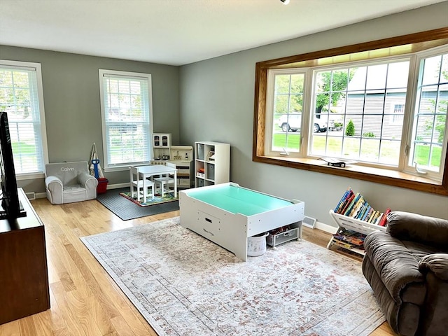 playroom with wood finished floors and baseboards