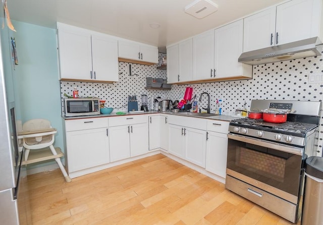 33 Williams St, New London, CT 06320 - kitchen with appliances with stainless steel finishes, under cabinet range hood, white cabinets, and light wood-style floors