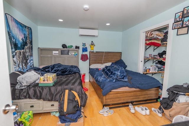 33 Williams St, New London, CT 06320 - bedroom with a wall mounted AC, wood finished floors, and recessed lighting