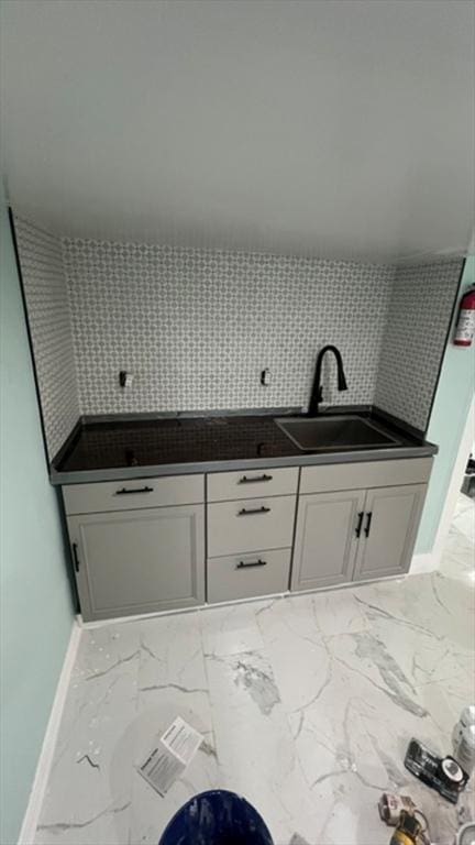 33 Williams St, New London, CT 06320 - kitchen featuring marble finish floors, white cabinetry, and tasteful backsplash