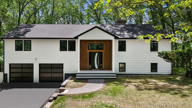 20 Howard Rd, Maynard, MA 01754 - raised ranch featuring driveway, a garage, roof with shingles, and a chimney