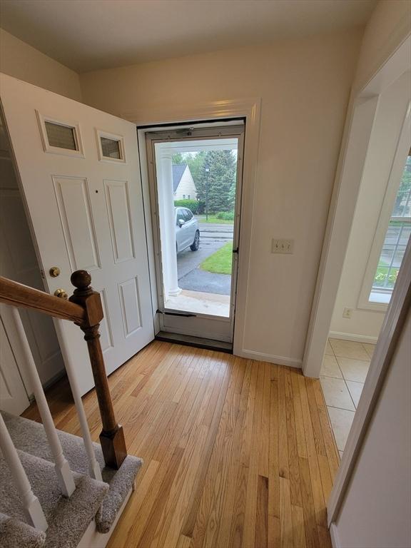 281 Rowley Bridge Rd Unit 7, Topsfield, MA 01983 - foyer with light wood-style flooring, baseboards, and stairs