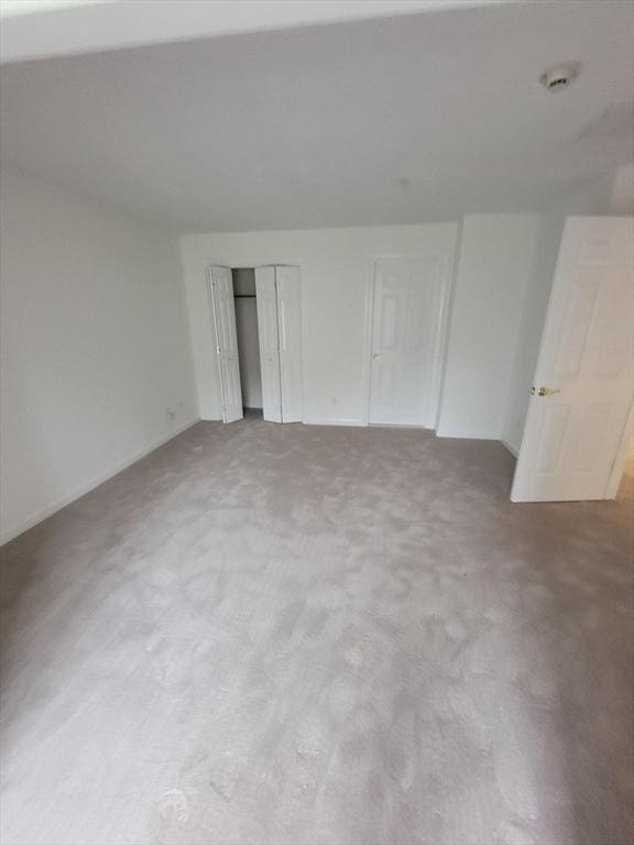 281 Rowley Bridge Rd Unit 7, Topsfield, MA 01983 - unfurnished bedroom with a closet, baseboards, and carpet flooring