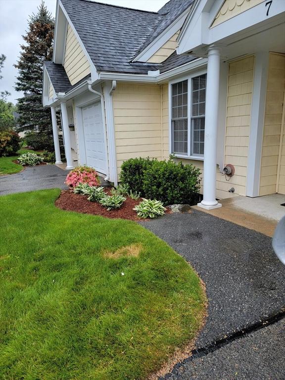 281 Rowley Bridge Rd Unit 7, Topsfield, MA 01983 - view of side of home with a shingled roof, a garage, a lawn, and driveway