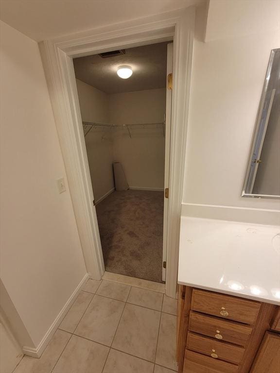 281 Rowley Bridge Rd Unit 7, Topsfield, MA 01983 - bathroom with vanity, tile patterned flooring, a spacious closet, and baseboards