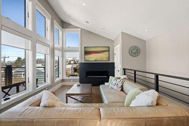 living room featuring a fireplace, recessed lighting, wood finished floors, high vaulted ceiling, and baseboards