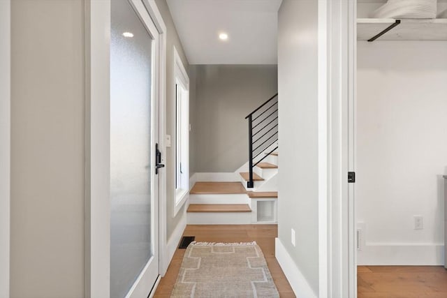 staircase featuring recessed lighting, visible vents, baseboards, and wood finished floors