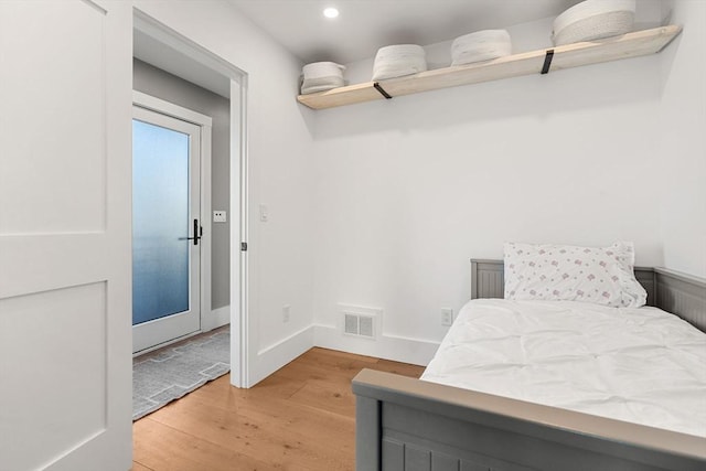 bedroom with baseboards, recessed lighting, visible vents, and light wood-style floors