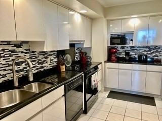 40 Village Rd Unit 606, Middleton, MA 01949 - kitchen featuring black appliances, decorative backsplash, white cabinets, and dark countertops