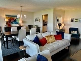 40 Village Rd Unit 606, Middleton, MA 01949 - living room featuring a chandelier, wood finished floors, and a textured ceiling