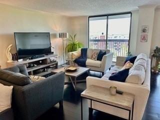 40 Village Rd Unit 606, Middleton, MA 01949 - living room featuring wood finished floors and a textured ceiling