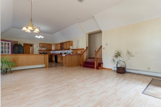 135 Main St, Blackstone, MA 01504 - kitchen featuring fridge, open floor plan, a chandelier, brown cabinetry, and light wood-type flooring
