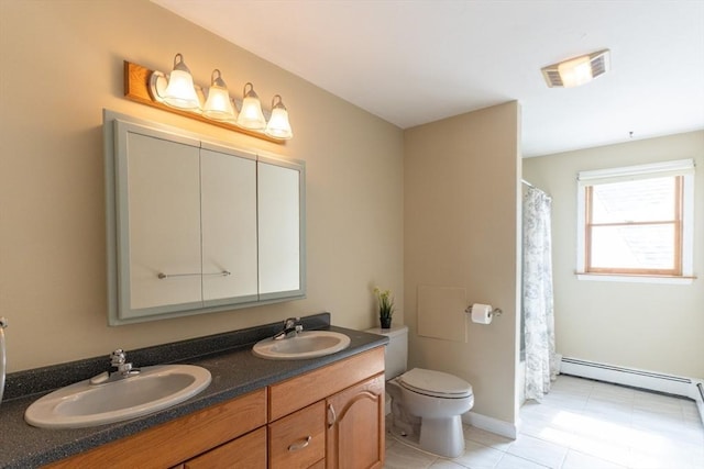 135 Main St, Blackstone, MA 01504 - bathroom with a baseboard heating unit, double vanity, and tile patterned floors