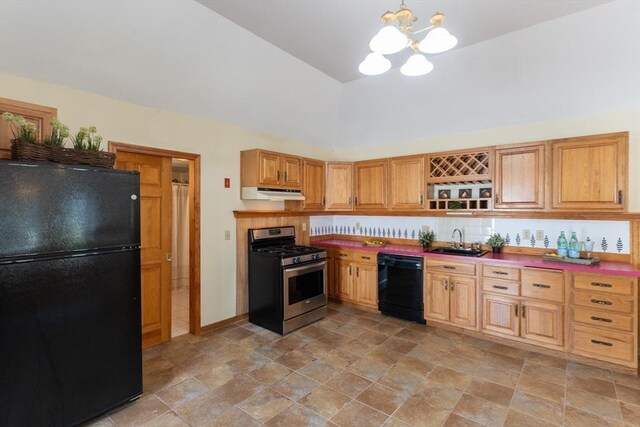 135 Main St, Blackstone, MA 01504 - kitchen with black appliances, under cabinet range hood, a chandelier, open shelves, and stone finish flooring