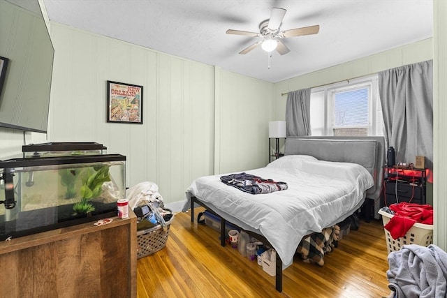 bedroom with light hardwood / wood-style floors and ceiling fan