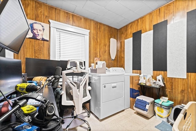 home office with wooden walls and washing machine and dryer