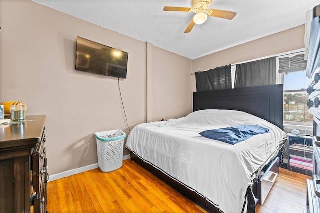 bedroom with ceiling fan and light hardwood / wood-style floors