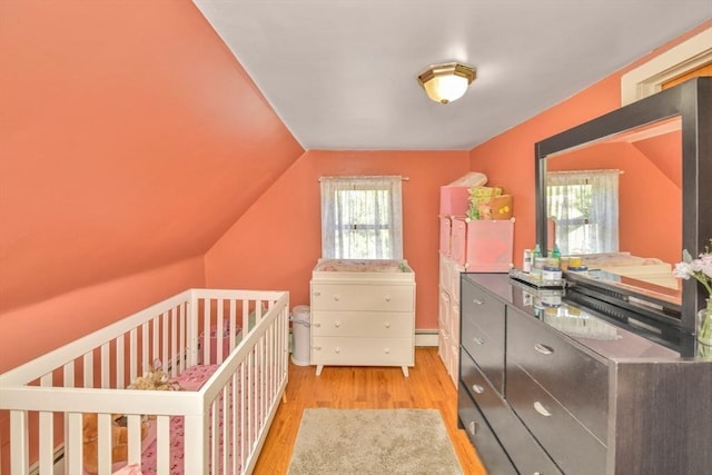 120 E Ashland St, Brockton, MA 02302 - bedroom featuring wood finished floors, a baseboard heating unit, and vaulted ceiling