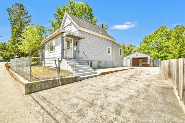 120 E Ashland St, Brockton, MA 02302 - view of front of property featuring an outbuilding, a garage, and a shingled roof