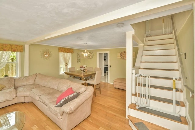 120 E Ashland St, Brockton, MA 02302 - living area featuring stairway, light wood-style flooring, and a chandelier
