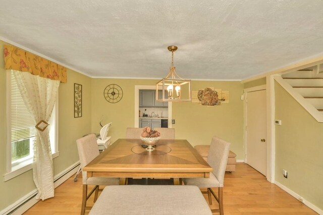 120 E Ashland St, Brockton, MA 02302 - dining area featuring baseboard heating, light wood-style floors, a chandelier, stairs, and crown molding