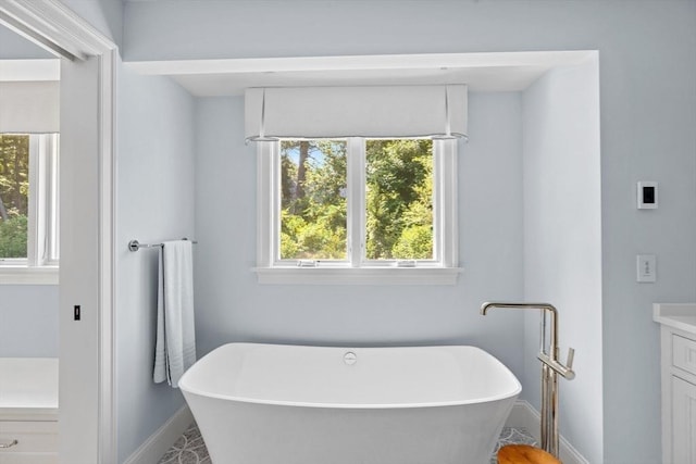 1164 Main St, Hingham, MA 02043 - bathroom featuring vanity, a freestanding bath, and baseboards