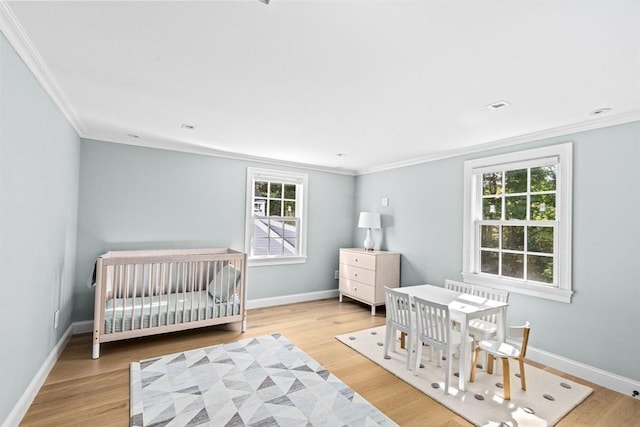 1164 Main St, Hingham, MA 02043 - bedroom featuring multiple windows, crown molding, wood finished floors, baseboards, and a nursery area