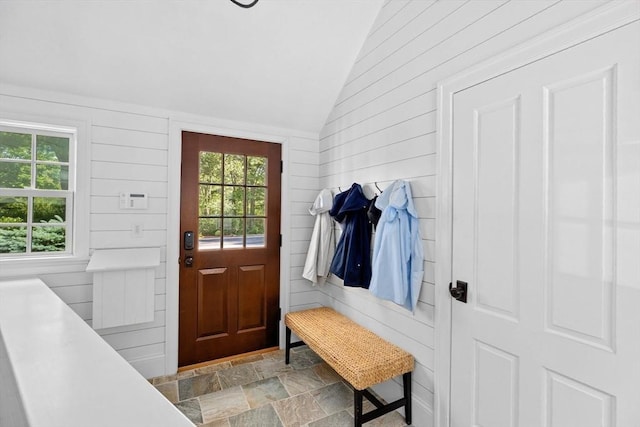 1164 Main St, Hingham, MA 02043 - mudroom featuring vaulted ceiling, plenty of natural light, wooden walls, and light stone finish floors