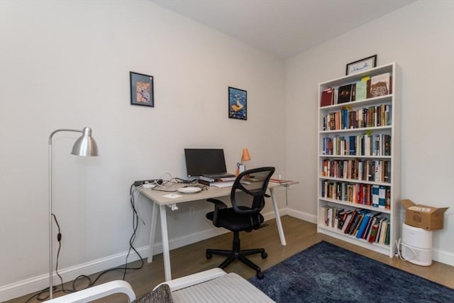 office area featuring baseboards and wood finished floors