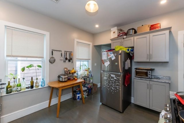kitchen with freestanding refrigerator, dark wood-type flooring, gray cabinets, recessed lighting, and baseboards