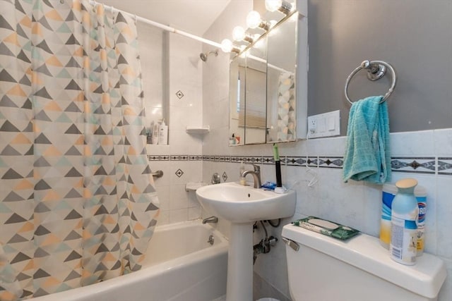 full bathroom with tile walls, shower / bath combo with shower curtain, and toilet