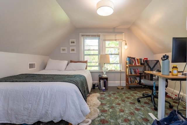 bedroom featuring vaulted ceiling, a desk, and baseboards