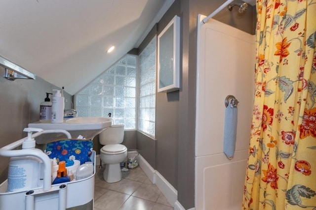 bathroom with lofted ceiling, tile patterned flooring, a shower with shower curtain, toilet, and baseboards