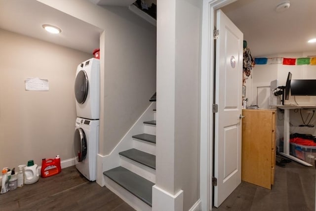 staircase with stacked washer / dryer, wood finished floors, and baseboards