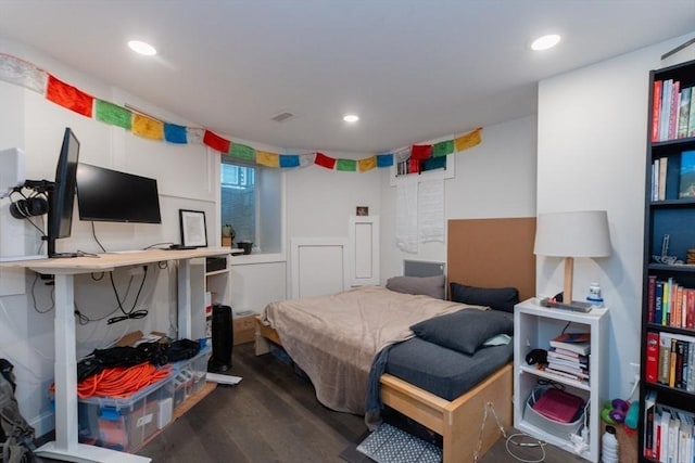 bedroom with wood finished floors and recessed lighting