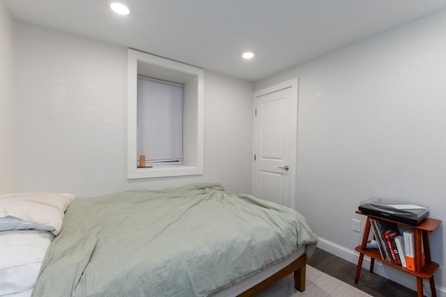 bedroom featuring wood finished floors, recessed lighting, and baseboards